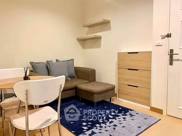 Cozy living room with modern furniture and stylish decor in a compact apartment.