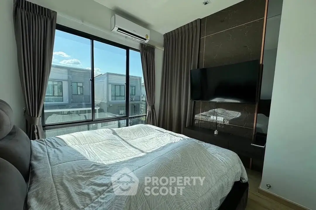 Modern bedroom with large window and stylish decor