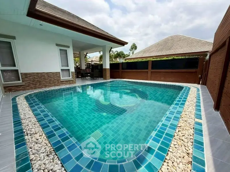Luxurious private pool in a modern villa with elegant stone accents and serene outdoor setting.