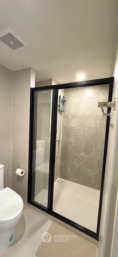 Modern bathroom with sleek shower enclosure and contemporary fixtures.