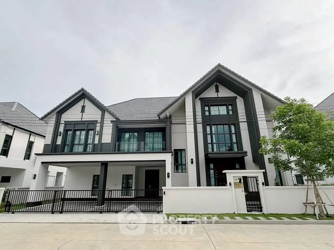 Stunning modern two-story house with sleek design and spacious driveway in a serene neighborhood.