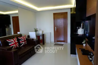 Modern living room with sleek design and stylish decor, featuring a leather sofa and open kitchen layout.