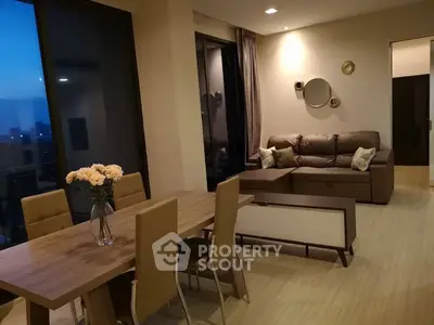 Stylish modern living room with cozy sofa and elegant dining area