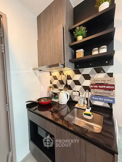 Modern compact kitchen with stylish backsplash and wooden cabinets, featuring a sleek countertop and built-in appliances.