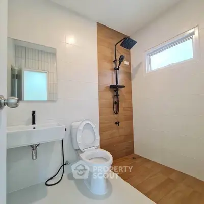 Modern bathroom with sleek fixtures and wood accent wall