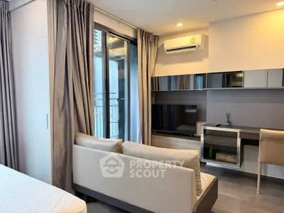 Modern living room with sleek furniture and balcony view in urban apartment