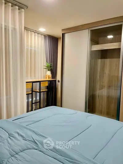Modern bedroom with sliding wardrobe and elegant curtains