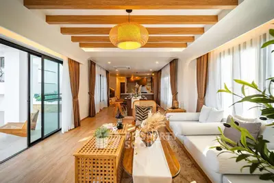 Luxurious open-plan living room with modern decor and wooden accents