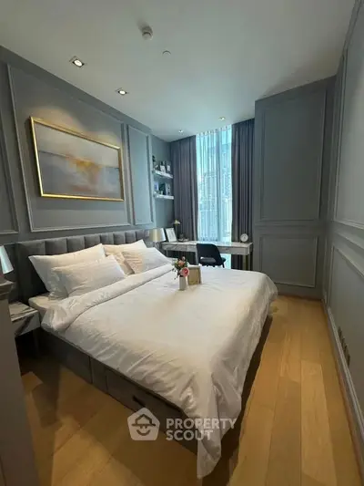 Luxurious bedroom with elegant decor and large window offering natural light