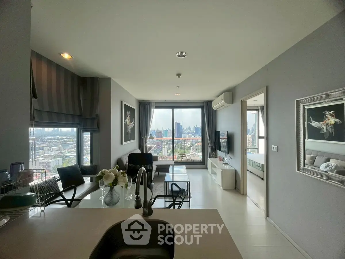 Stunning modern living room with city view, open layout, and elegant decor in high-rise apartment.
