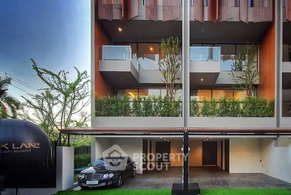 Modern luxury apartment building with sleek design and spacious balconies.