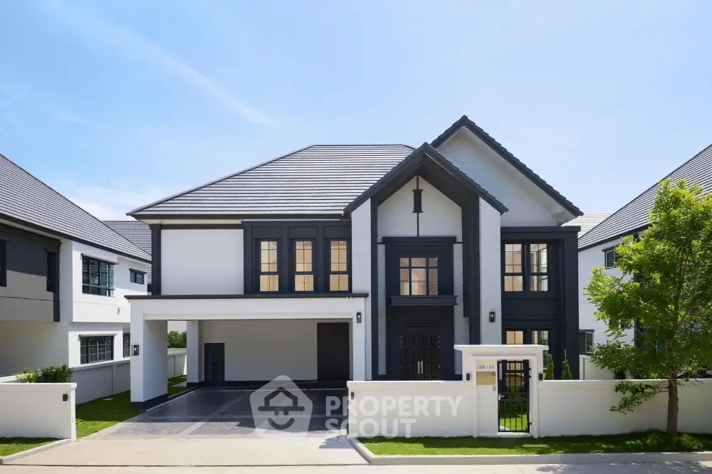 Elegant modern two-story house with spacious driveway and manicured lawn