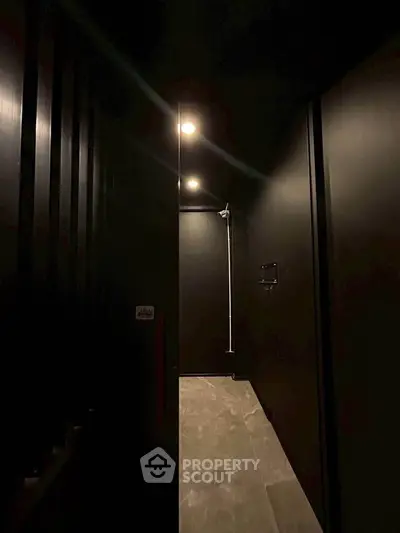 Modern minimalist bathroom with sleek black walls and ambient lighting