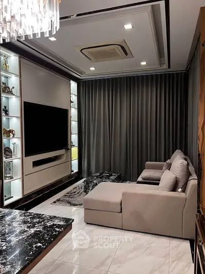 Luxurious living room with modern decor, marble flooring, and elegant lighting.