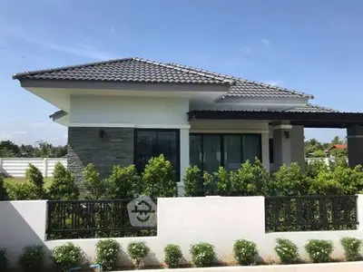 Charming single-story house with modern design and lush greenery in a serene neighborhood.