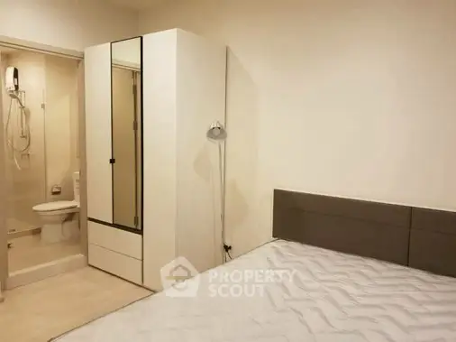 Modern bedroom with ensuite bathroom and sleek wardrobe design