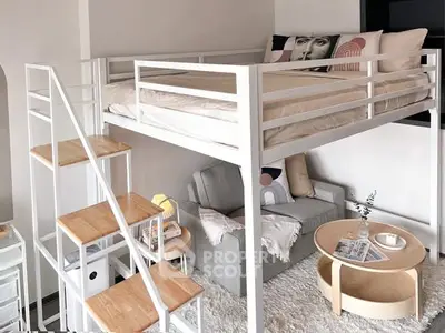 Stylish loft bed with cozy living area underneath, perfect for maximizing small spaces.