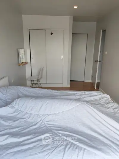 Cozy bedroom with white bedding and minimalist decor