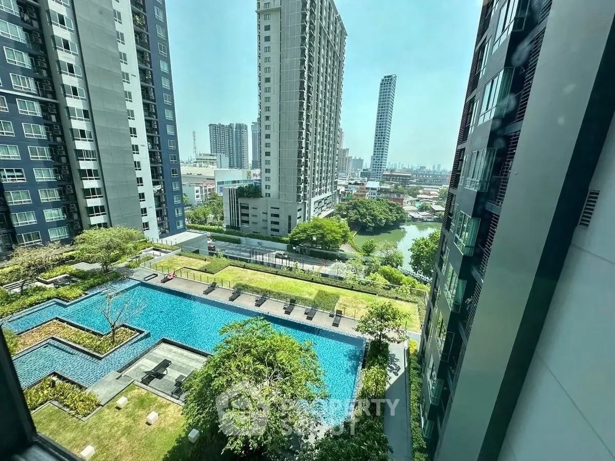 Stunning high-rise apartment view with pool and lush greenery
