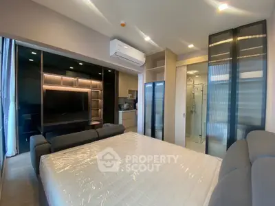 Modern bedroom with sleek design, featuring a cozy bed, built-in wardrobe, and stylish lighting.