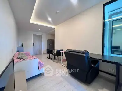 Modern living room with sleek furniture and ambient lighting in a contemporary apartment.