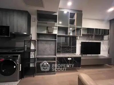 Modern living room with sleek black cabinetry and wall-mounted TV