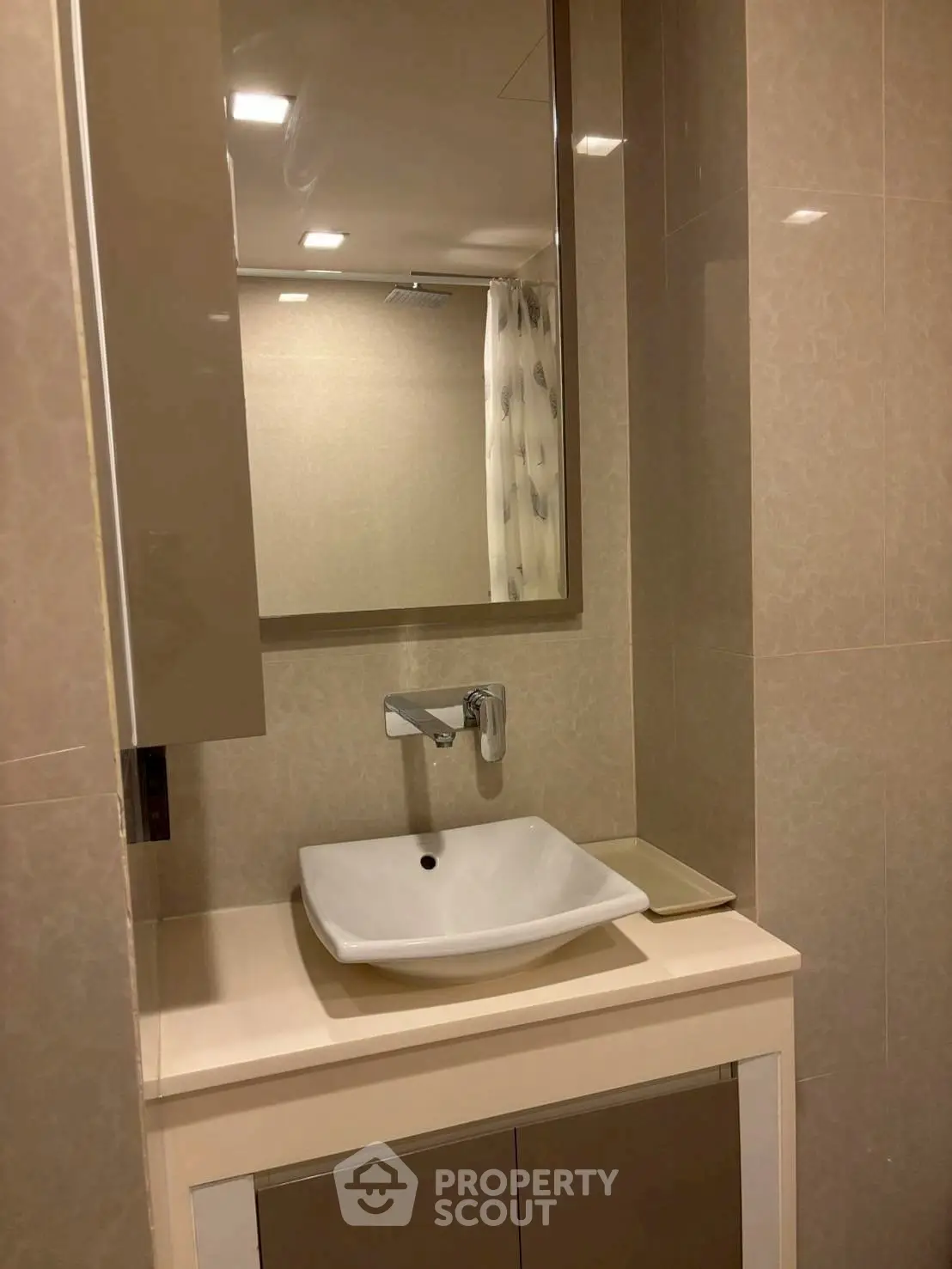Modern bathroom with sleek sink and mirror in contemporary design.