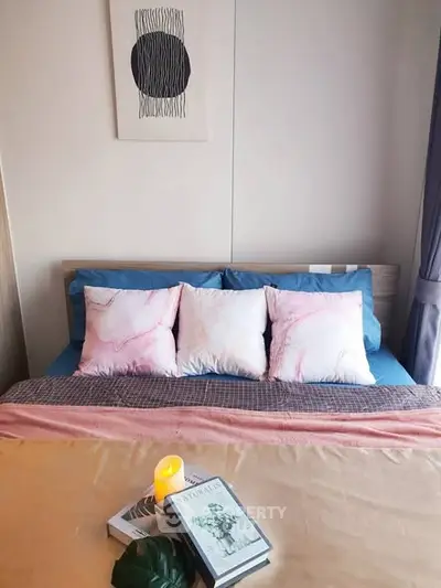 Cozy bedroom with stylish decor and soft lighting, perfect for relaxation and comfort.
