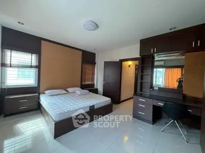 Spacious modern bedroom with sleek furniture and natural light