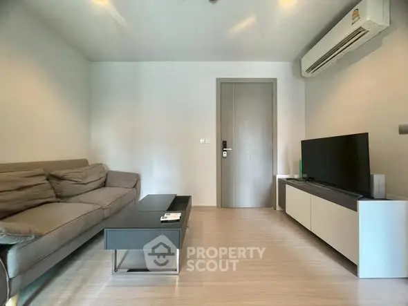 Modern living room with sleek furniture and air conditioning, perfect for relaxation and entertainment.