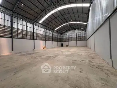 Spacious industrial warehouse with high ceilings and ample storage space.