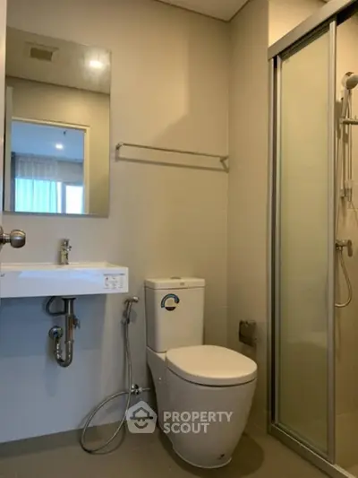 Modern bathroom with sleek fixtures and glass shower enclosure