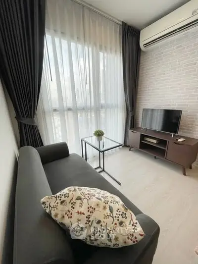 Modern living room with sleek furniture and large window, perfect for urban living.