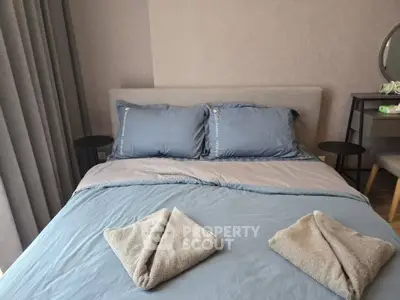 Cozy bedroom with stylish decor and plush bedding in modern apartment
