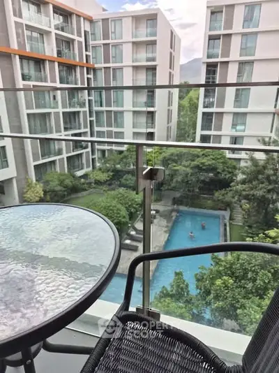 Modern apartment balcony with pool view in urban setting