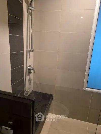 Modern bathroom with sleek shower design and neutral tiles