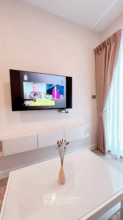 Modern living room with wall-mounted TV and elegant decor