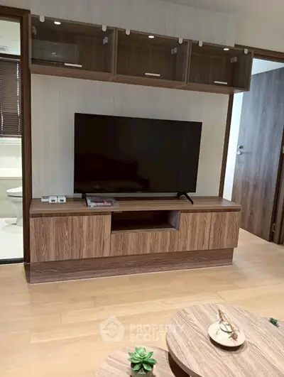 Modern living room with sleek TV stand and wooden flooring