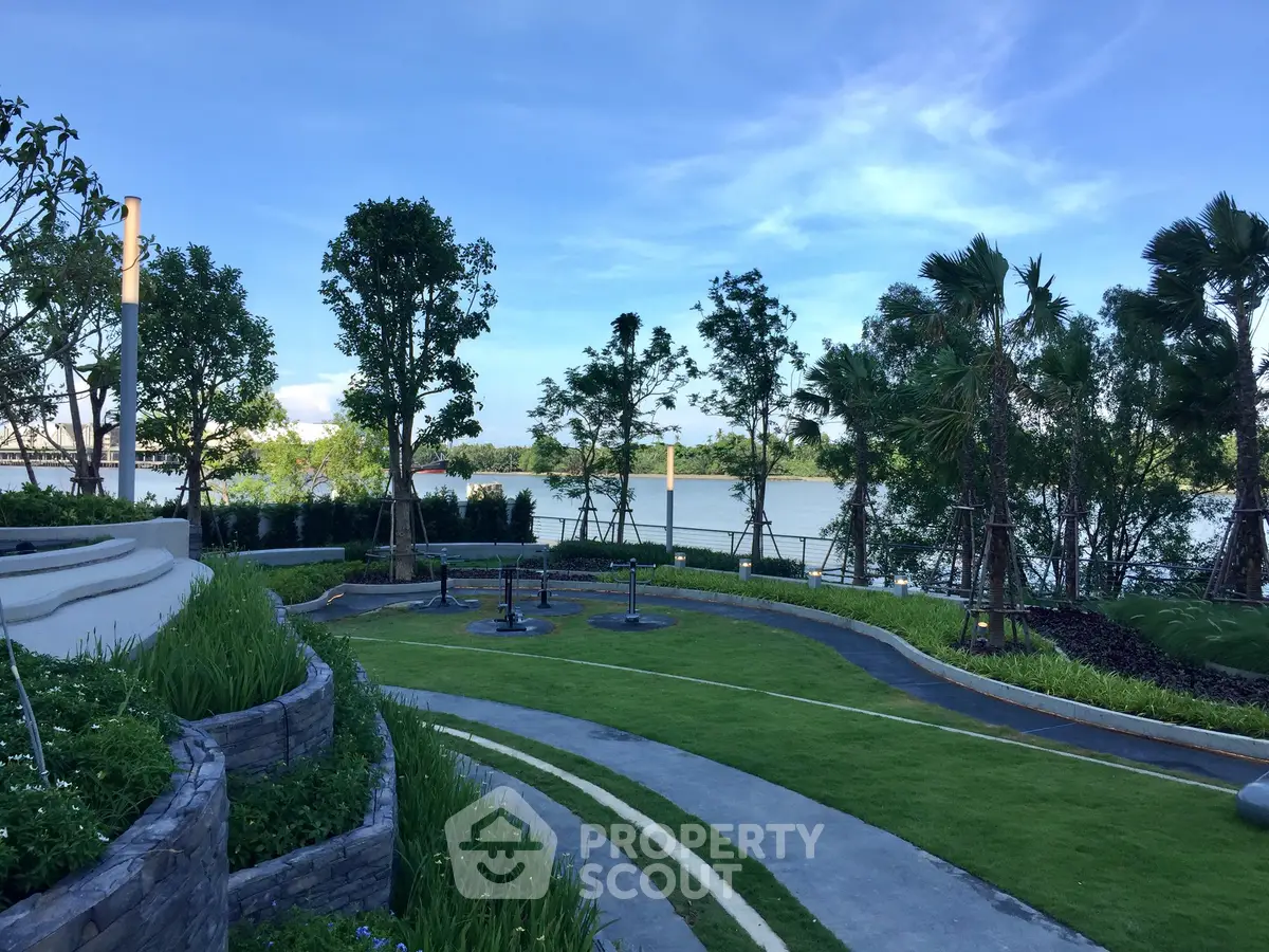 Stunning riverside garden with lush greenery and serene water views, perfect for relaxation and outdoor activities.
