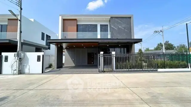Modern two-story house with sleek design and spacious driveway