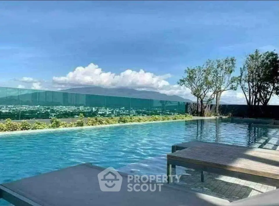 Luxurious rooftop pool with stunning city and mountain views, perfect for relaxation and leisure.