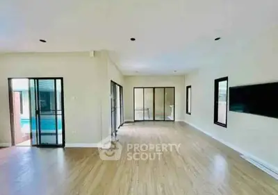 Spacious modern living room with pool view and sleek design