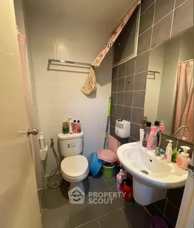 Compact bathroom with modern fixtures and ample storage space.