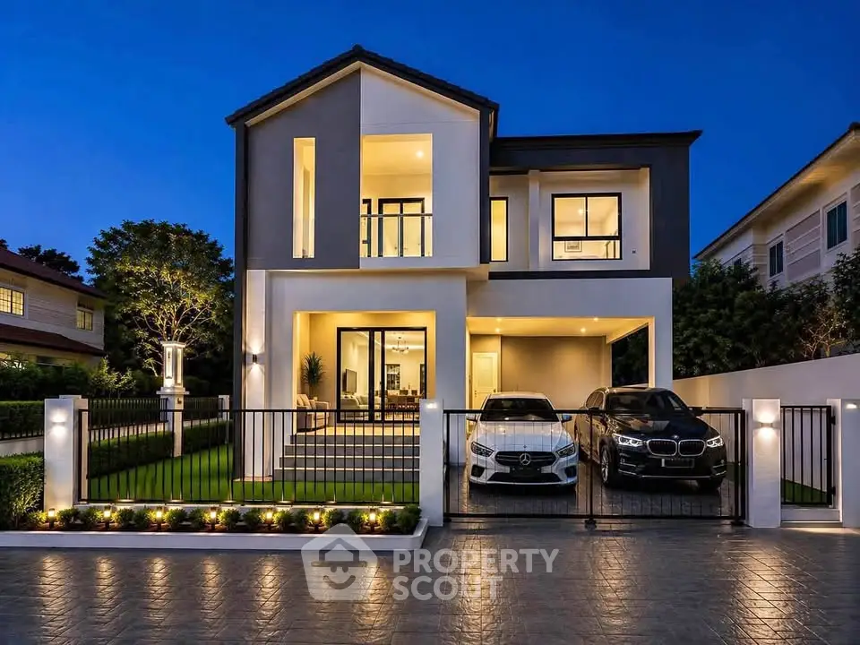 Luxurious modern two-story house with illuminated facade and spacious driveway at dusk.