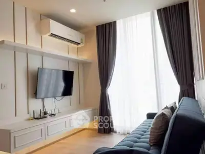 Modern living room with sleek design, featuring a wall-mounted TV and stylish sofa.