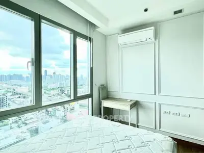 Bright bedroom with city view and modern air conditioning unit.