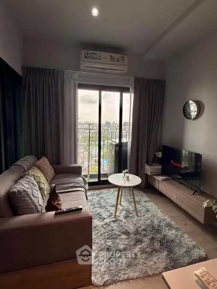 Cozy living room with city view, modern furniture, and natural light.