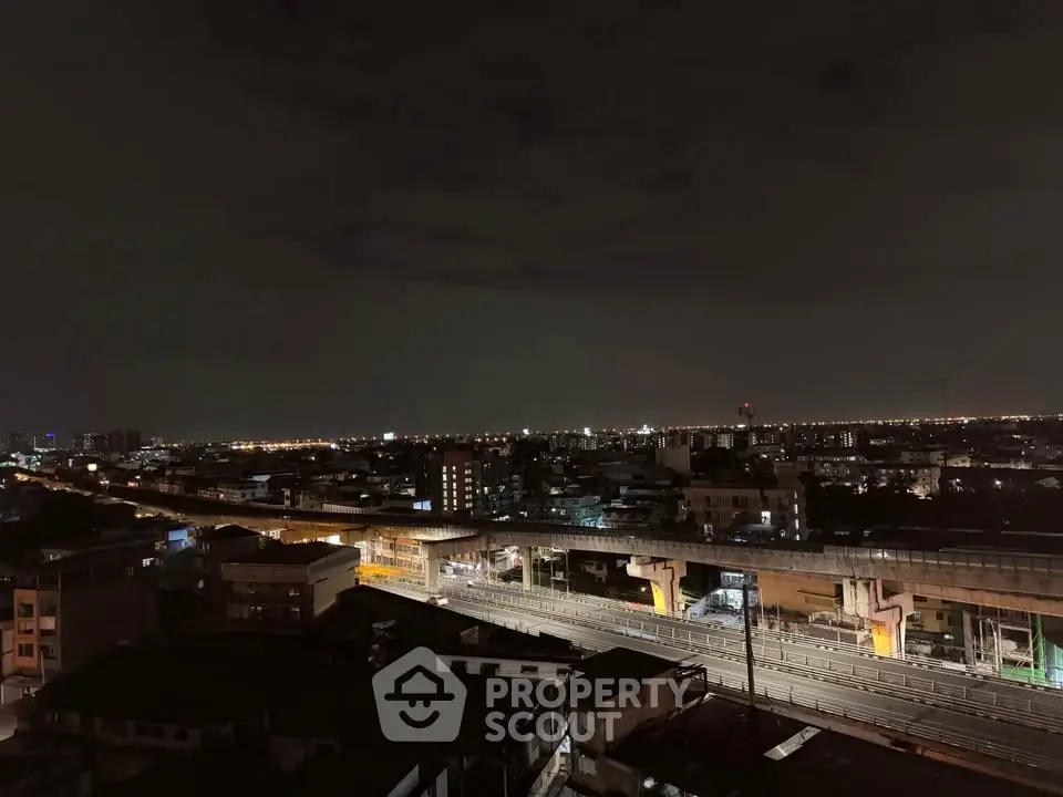 Stunning cityscape view from high-rise apartment at night with illuminated skyline.