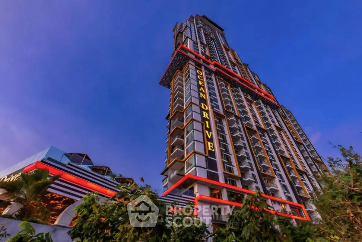 Stunning modern high-rise building with unique architectural design and vibrant lighting.