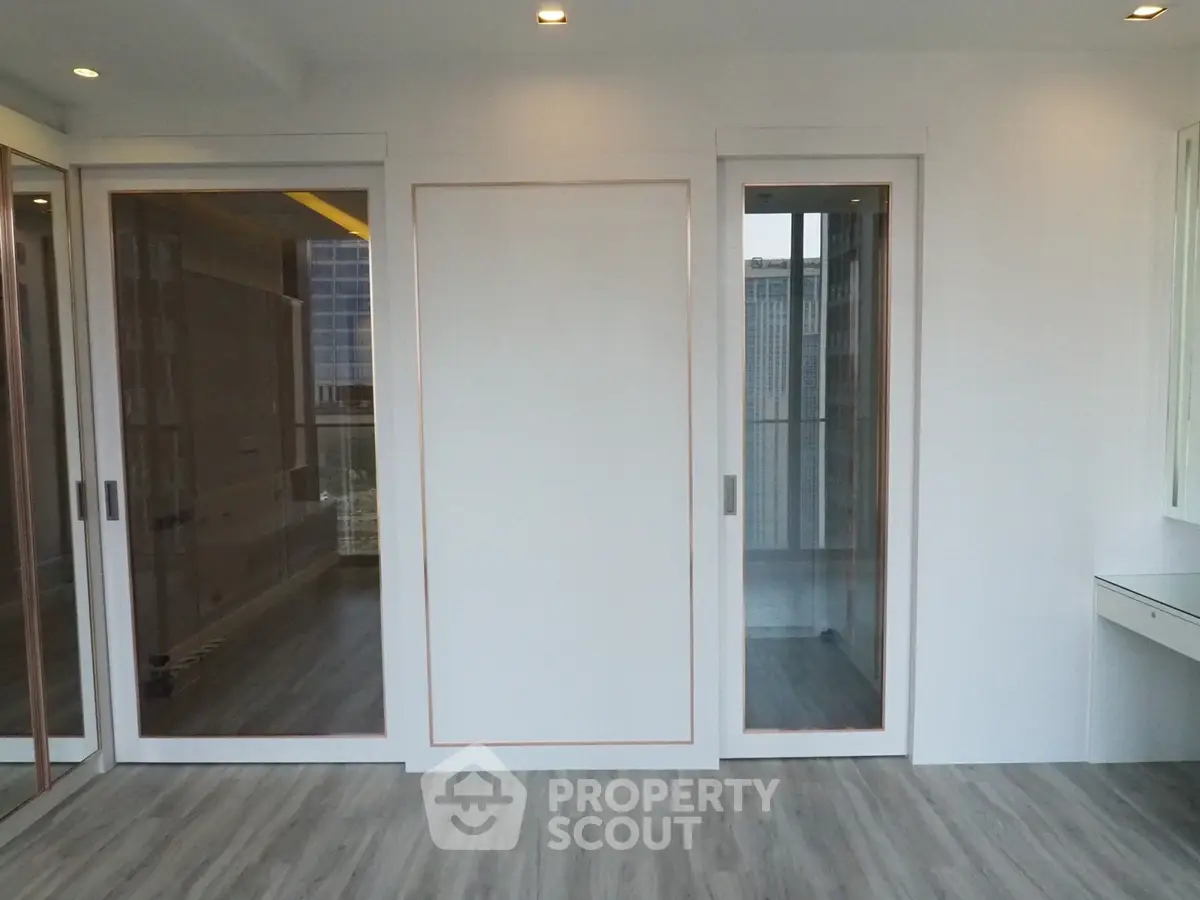 Modern interior with sliding glass doors and sleek flooring in a bright apartment.